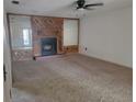 Cozy living room with carpet flooring, wood paneling, and a fireplace at 2213 Eastmeadows Rd, Lakeland, FL 33812