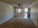 Bright living room with carpet flooring, ceiling fan, and natural light from the window at 2213 Eastmeadows Rd, Lakeland, FL 33812