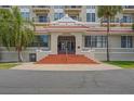 Stately building entrance with red-tiled steps and classic architectural details, including a covered entryway at 235 6Th Nw St # 307, Winter Haven, FL 33881
