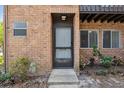 Close-up of the exterior entrance with red brick facade and well-maintained landscaping at 2369 Tom Jones St # 8, Orlando, FL 32839