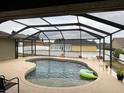 Backyard pool boasts a screened enclosure providing a private and refreshing outdoor oasis at 2663 Brookside Bluff Loop, Lakeland, FL 33813