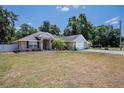 Charming brick home with attached two-car garage and a well-manicured lawn at 2933 Blackwater Oaks Dr, Mulberry, FL 33860