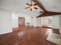 Living room with hardwood floors, vaulted ceilings, ceiling fans, and a unique entrance at 3002 Helms Dr, Auburndale, FL 33823
