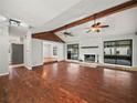 Bright living room featuring hardwood floors, a stone fireplace, and access to the pool area at 3002 Helms Dr, Auburndale, FL 33823