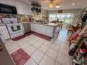 Bright kitchen with white cabinets, modern appliances, a garden window and a cozy breakfast nook at 3233 Gardner Rd, Lakeland, FL 33810