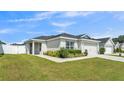 Charming single-Gathering home featuring a well-manicured lawn, a two-car garage, and complemented by lush landscaping at 3946 Willow Ridge Dr, Lakeland, FL 33810