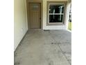 Concrete front porch showing the front door and window of the unit at 4038 Oak Loop # 103, Mulberry, FL 33860