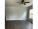 Living room featuring hard surface floors, a ceiling fan, and a window to the exterior at 4038 Oak Loop # 103, Mulberry, FL 33860
