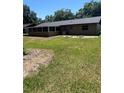 Spacious backyard with green grass and trees on a sunny day at 4127 Grove Pl, Lakeland, FL 33810
