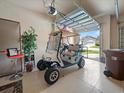 Bright garage featuring an electric golf cart and ample space for storage and parking at 4193 Stone Creek Loop, Lake Wales, FL 33859
