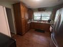 Traditional kitchen featuring wood cabinets, modern appliances, and a window over the sink at 427 Longfellow Blvd, Lakeland, FL 33801