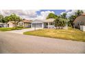 A well-kept home featuring a spacious driveway, attached garage, mature landscaping and inviting curb appeal at 4976 Pleasant Hollow Trl, Lakeland, FL 33811