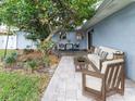 Private backyard patio with outdoor seating, mature landscaping, and ample space for entertaining at 502 Duchess Dr, Lakeland, FL 33803
