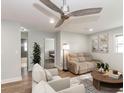 Bright living room with a ceiling fan, plush seating, and views into other rooms of the home at 502 Duchess Dr, Lakeland, FL 33803