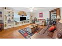 Bright living room with built-in shelves, hardwood floors, and sofas at 512 Cameo Dr, Lakeland, FL 33803