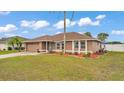 Beautiful exterior view of a single-story home with a manicured lawn and mature landscaping at 5246 Montserrat Dr, Lakeland, FL 33812