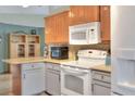 Bright kitchen featuring two-tone cabinets, updated appliances, and ample counter space, ready for cooking at 525 Eagle Run, Lakeland, FL 33809