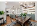 Open-concept kitchen with hardwood floors, island, modern cabinets, and views of the dining room at 527 W Park St, Lakeland, FL 33803