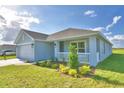 Well-manicured front yard and landscaping complement this home's exterior, complete with a covered entryway at 580 Jett Ln, Davenport, FL 33837
