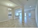 Spacious living area with tile flooring and views into the open-concept kitchen, perfect for entertaining at 580 Jett Ln, Davenport, FL 33837