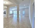 Open concept living room with tile floors and neutral paint, flowing into the kitchen and dining area at 580 Jett Ln, Davenport, FL 33837
