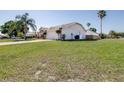 Spacious single-story house featuring a lush lawn, a wide driveway, and mature landscaping at 633 Heather Glen Loop, Winter Haven, FL 33884