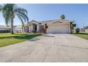 Well-maintained single-story home boasts a two-car garage, a wide driveway, and mature landscaping at 633 Heather Glen Loop, Winter Haven, FL 33884