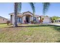 Inviting single-story house with a manicured lawn, trimmed shrubs, and a welcoming front entrance at 633 Heather Glen Loop, Winter Haven, FL 33884