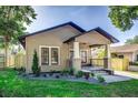 A cozy single-story home featuring a covered porch with stylish accents and manicured landscaping at 737 Johnson Ave, Lakeland, FL 33801