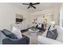 Open-concept living room boasts large windows, neutral tones, hardwood floors, and stylish furnishings at 737 Johnson Ave, Lakeland, FL 33801