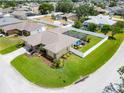 Aerial view of a home with a screened pool, fenced yard, mature landscaping, and a well-kept lawn at 7890 Ashford Dr, Lakeland, FL 33810
