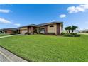 Beautifully landscaped front yard of a charming single-story home with mature trees and a driveway at 7890 Ashford Dr, Lakeland, FL 33810