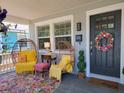 Inviting front porch featuring comfortable wicker seating, stylish decor, and a welcoming entrance at 807 Osceola St, Lakeland, FL 33801