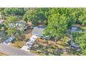 Aerial view of home showcasing mature trees, fenced backyard, and driveway at 819 Swann Dr, Lakeland, FL 33809