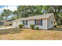 A charming home featuring durable siding and complementary shutters at 819 Swann Dr, Lakeland, FL 33809