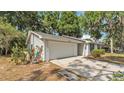 Ranch-style home with attached garage and concrete driveway at 819 Swann Dr, Lakeland, FL 33809