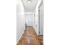 Long hallway features tile flooring and leads to various rooms in the home at 983 Revere Ave, Haines City, FL 33844