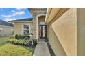 Elegant front entrance with stone details, double doors, and tasteful landscaping at 1036 Stoney Creek Dr, Lakeland, FL 33811