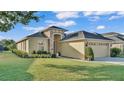 Inviting single-story home with lush green lawn and stone accents around the front entryway at 1036 Stoney Creek Dr, Lakeland, FL 33811