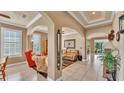 Open-concept living spaces with tile flooring, arched doorways, and neutral color palette at 1036 Stoney Creek Dr, Lakeland, FL 33811