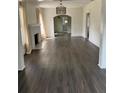 Bright living room featuring a decorative fireplace, arched doorway, and modern flooring at 1217 King Ave, Lakeland, FL 33803