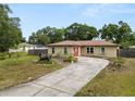 Single-story home featuring a well-manicured front yard with a distinctive bull statue at 137 Leitha Way, Lakeland, FL 33809