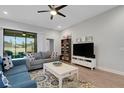 Cozy living room with a ceiling fan, comfortable seating, and sliding glass door at 1470 Silver Leaf Dr, Lakeland, FL 33813