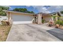 Attached garage and large driveway with pergola covered entry at 1808 Stonecrest Ct, Lakeland, FL 33813