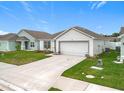 Beautiful single-story home showcases a manicured lawn and a convenient two-car garage at 1821 Thompson Preserve Boulevard, Bartow, FL 33830