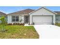 Inviting single-story home features a well-maintained lawn and a two-car garage at 1821 Thompson Preserve Boulevard, Bartow, FL 33830