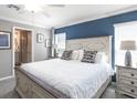 Bright bedroom features a large bed, stylish decor, and ample natural light from the windows at 1837 Noble Dr, Davenport, FL 33837