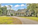 Charming single-story home with a welcoming front porch and well-manicured lawn at 2070 W Lake Hamilton Dr, Winter Haven, FL 33881