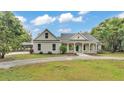 Beautiful home featuring a covered parking area, well-maintained landscaping, and a cozy entrance at 2070 W Lake Hamilton Dr, Winter Haven, FL 33881