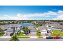 Aerial view of homes in a lakeside community with mature landscaping and inviting streetscapes at 2318 Rush Bay Way, Orlando, FL 32824